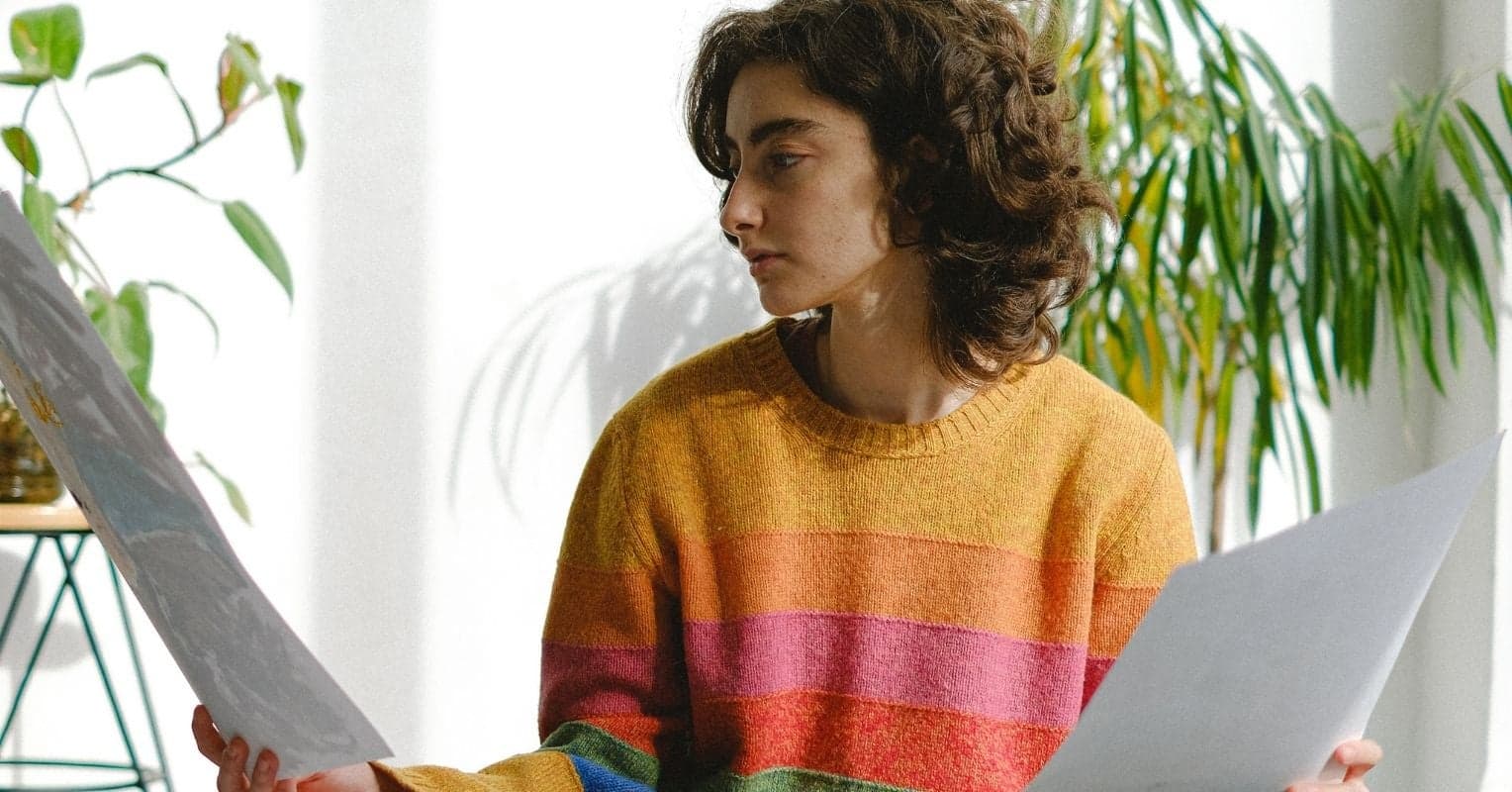 A woman looking at two drawings