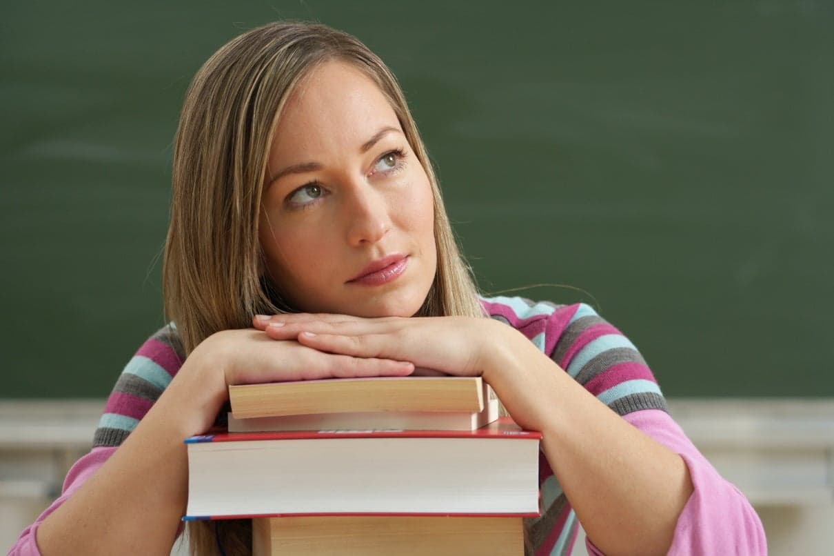 Picture of a student pondering over books