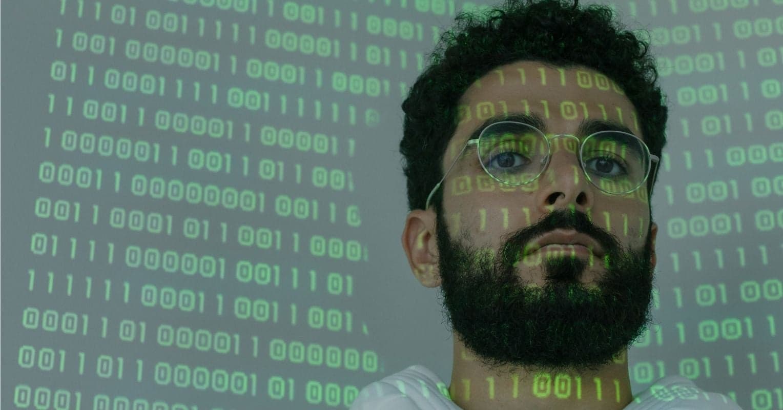 A man with lines of code on his face