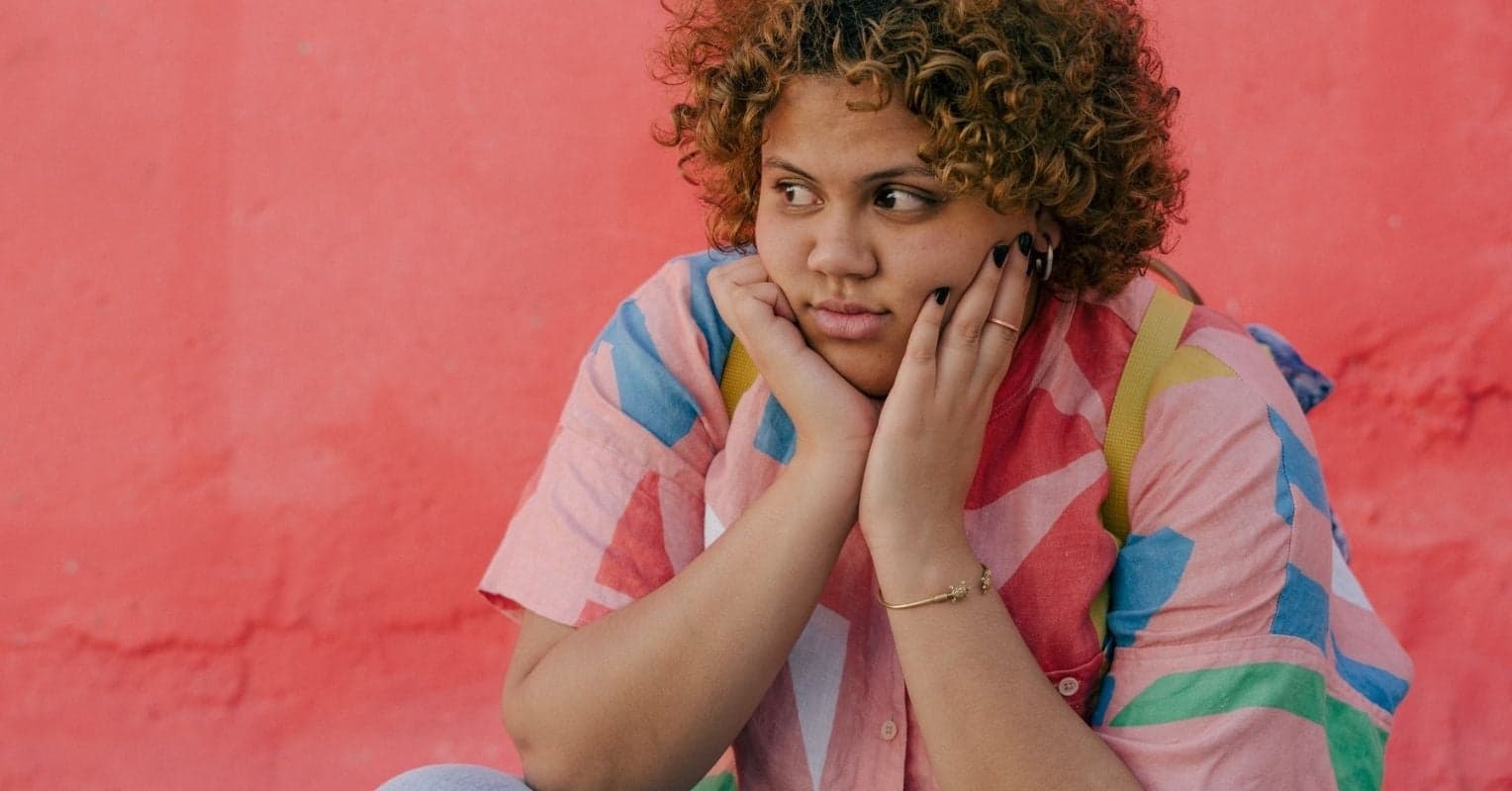 Woman with colorful shirt looks in the distance
