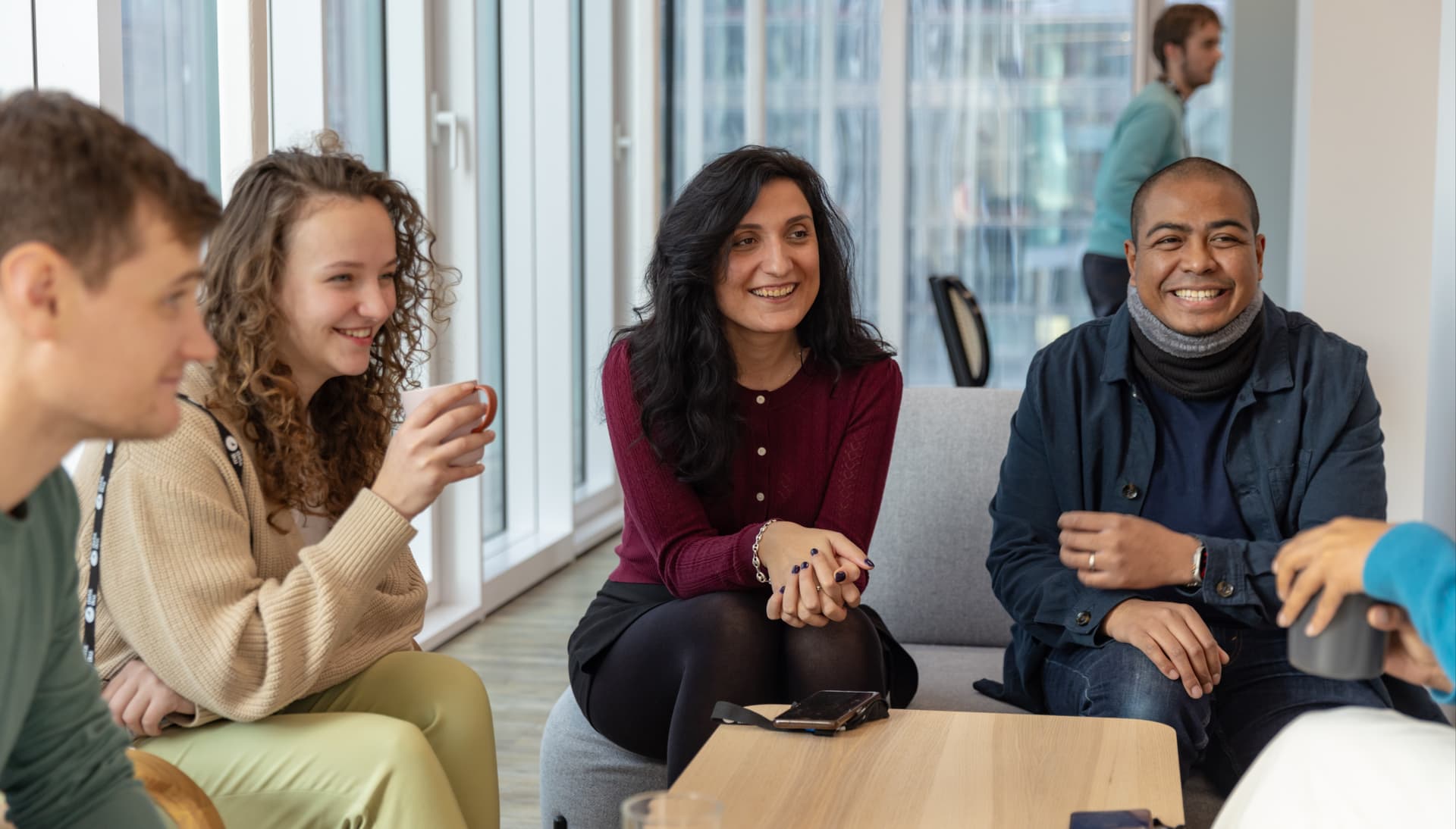 Catching up for coffee in our Paris Office social area